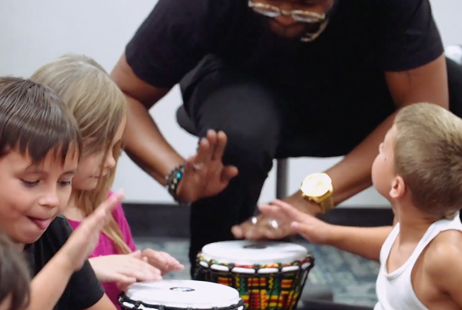 Music Moves instructs children as they play drums in the classroom.